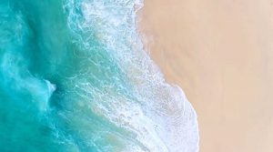 Tropical beach waves aerial view