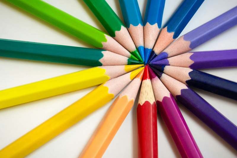 Circle of bright coloured pencils with sharpened tips meeting in the centre, representing creative agency work