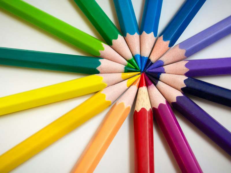 Circle of bright coloured pencils with sharpened tips meeting in the centre, representing creative agency work